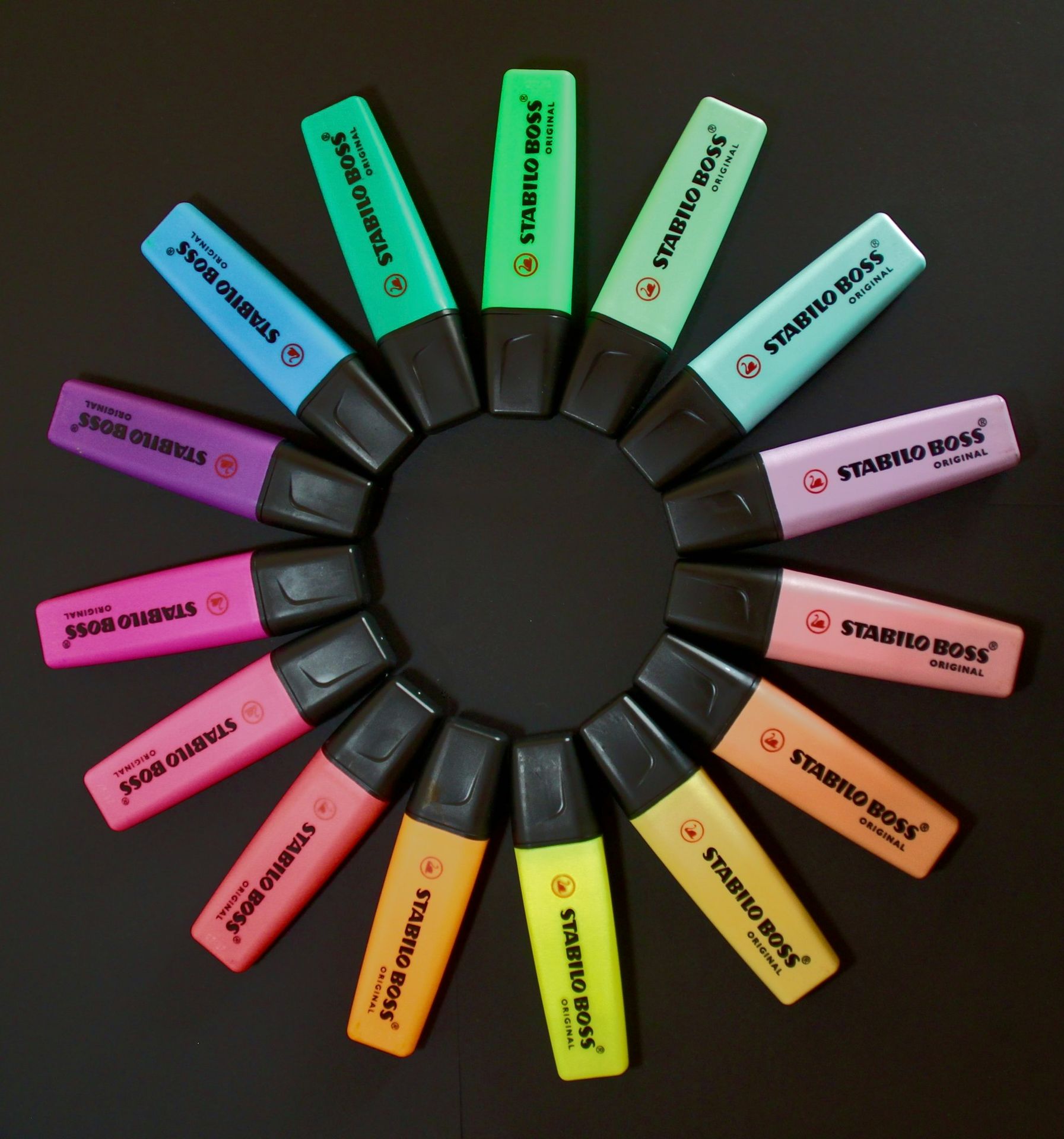 a circle of different colored batteries on a table